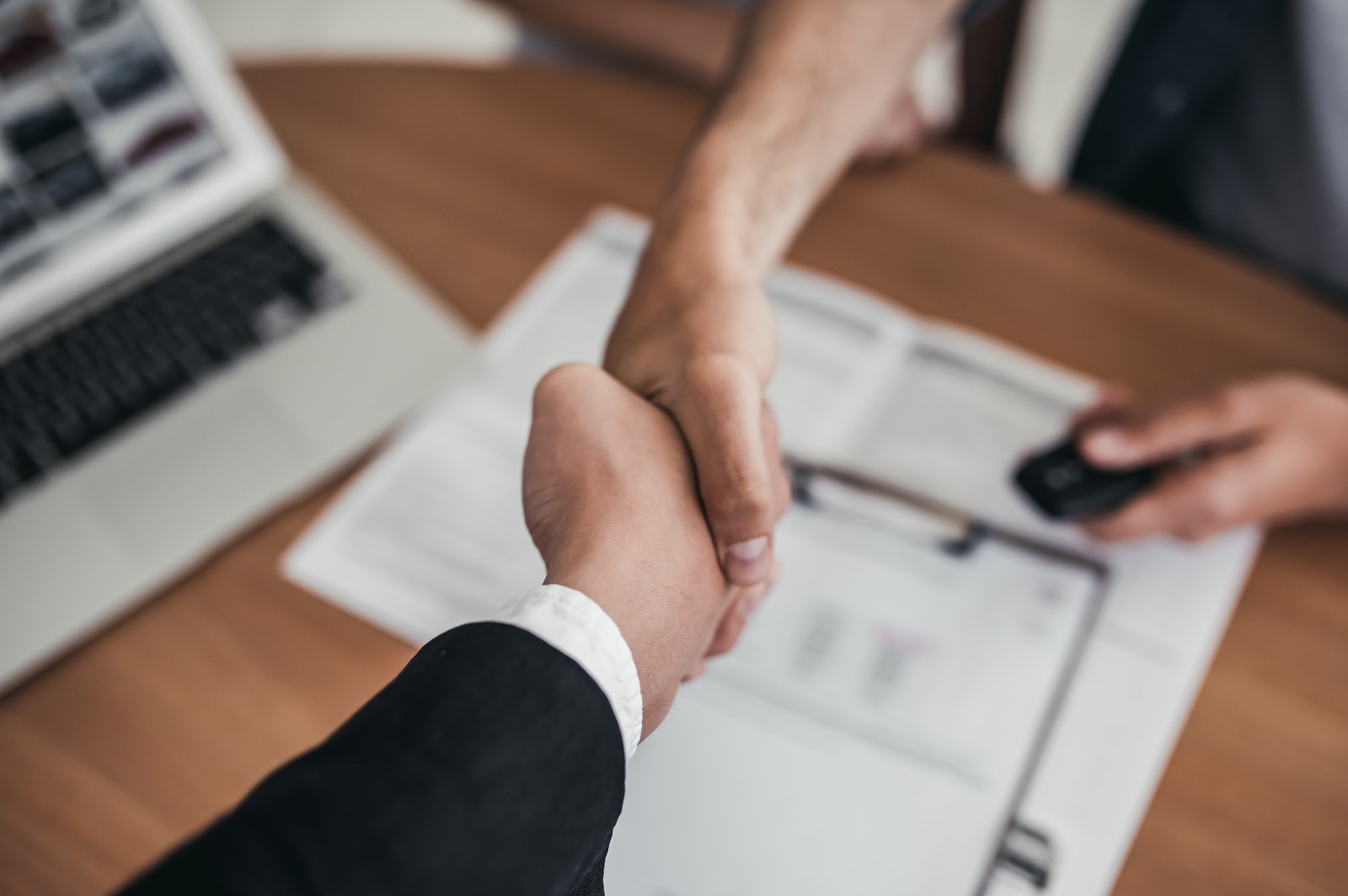 Two people shaking hands over business