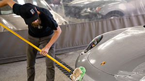 Man details front of a vehicle